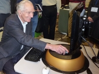 Photo of Prof. James Livingston trying a maglev haptic device